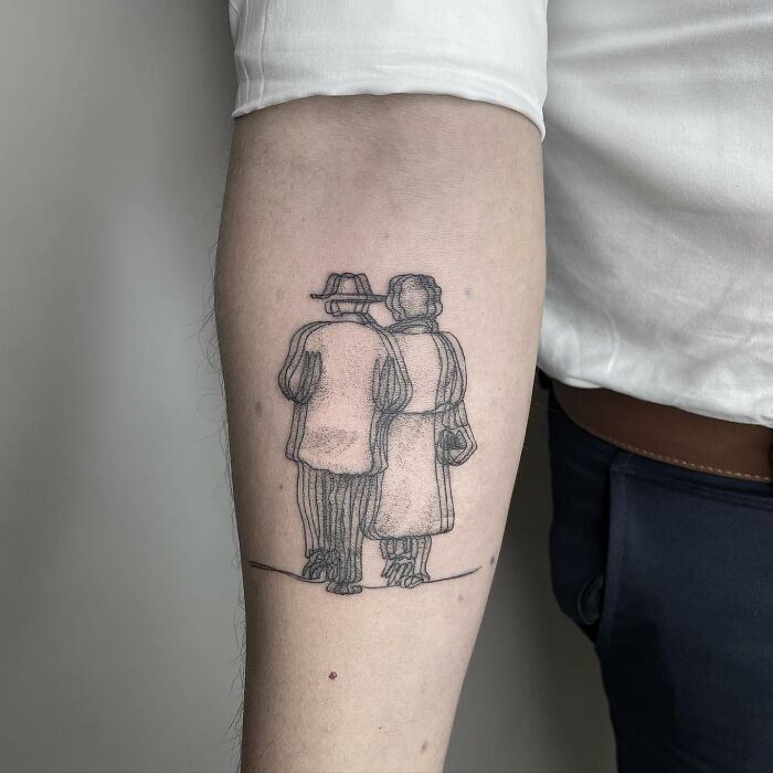 Tattoo of a couple walking arm in arm on an arm, designed to create a ‘moving’ illusion.