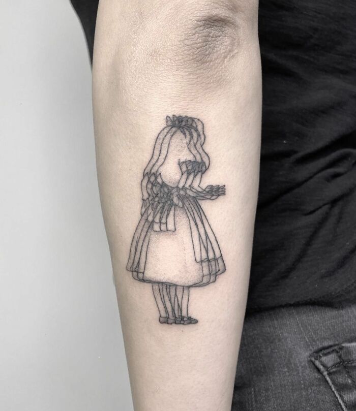 "Optical illusion tattoo of a girl on forearm, creating a moving effect."