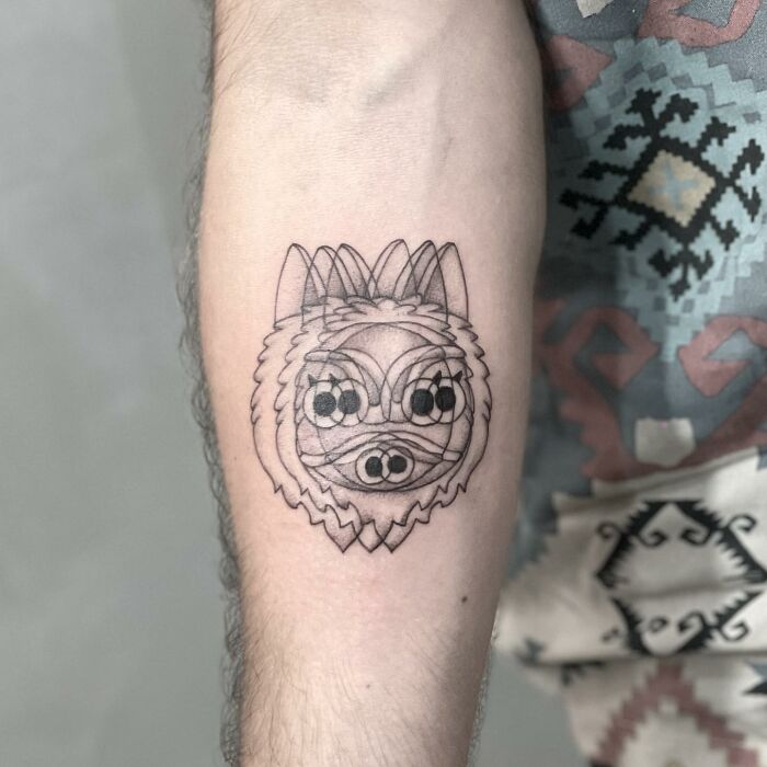 Geometric tattoo of a wolf on arm, showcasing intricate linework and "moving" illusion.