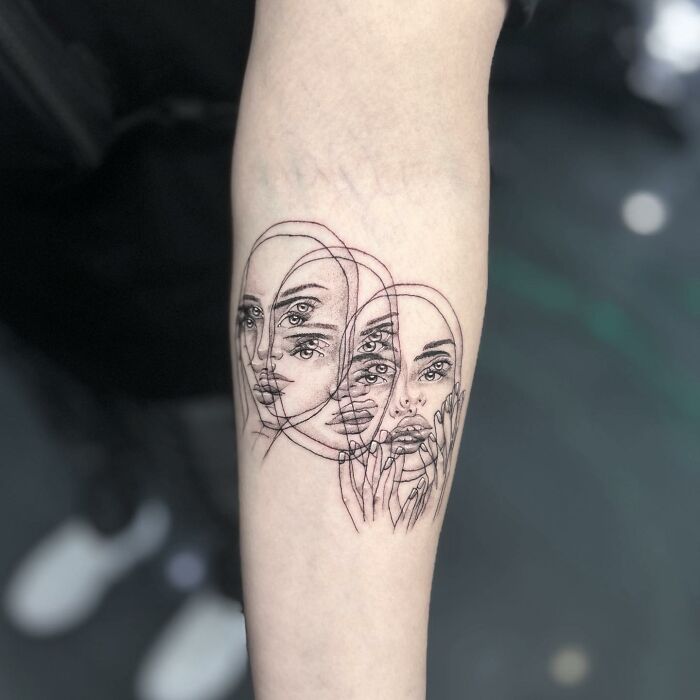 Abstract moving tattoos on forearm, showcasing three overlapping faces with mesmerizing optical illusion effects.
