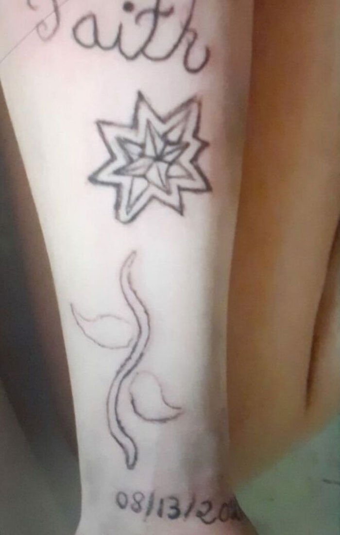 Bad tattoos featuring the word "Faith," an abstract star, and a date on someone's forearm.