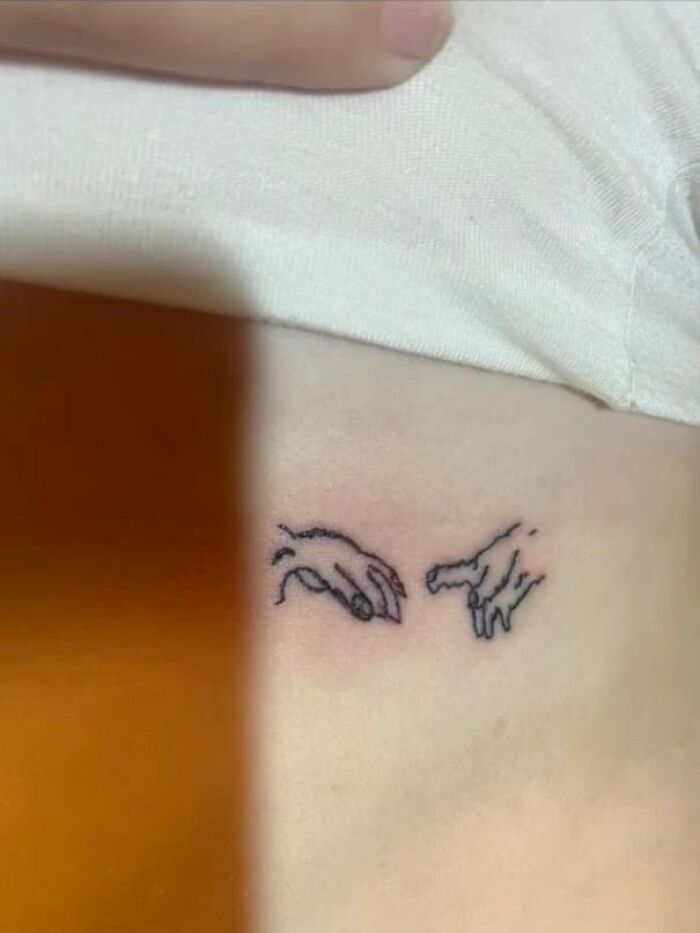 Hilariously bad tattoos: poorly drawn hands on skin, resembling famous artwork but executed awkwardly.
