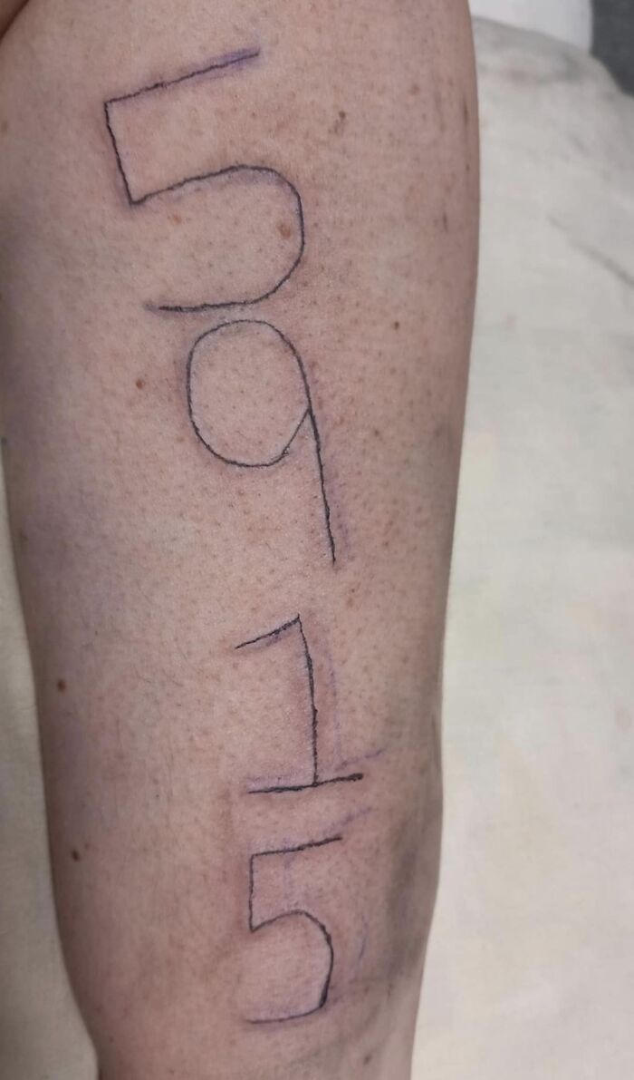Poorly done tattoo with uneven lines on a person's arm.
