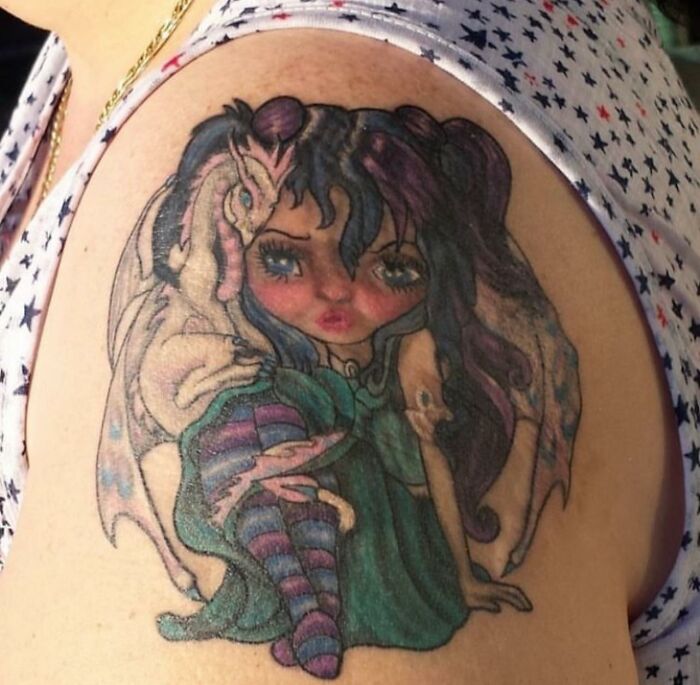Bad tattoos: colorful cartoon girl with a dragon, inkshaming example.