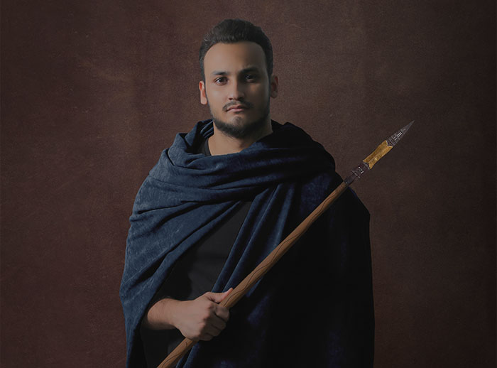 Person standing and holding spear