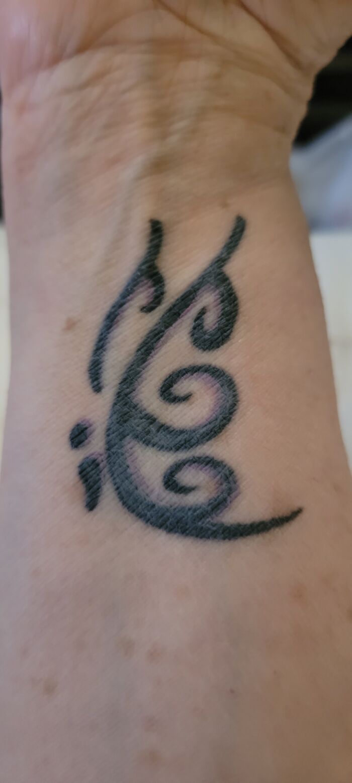 Coolest looking tattoo with swirling black ink design on a person's forearm.