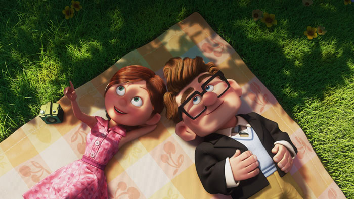 A cartoon couple lies on a picnic blanket, smiling at the sky.
