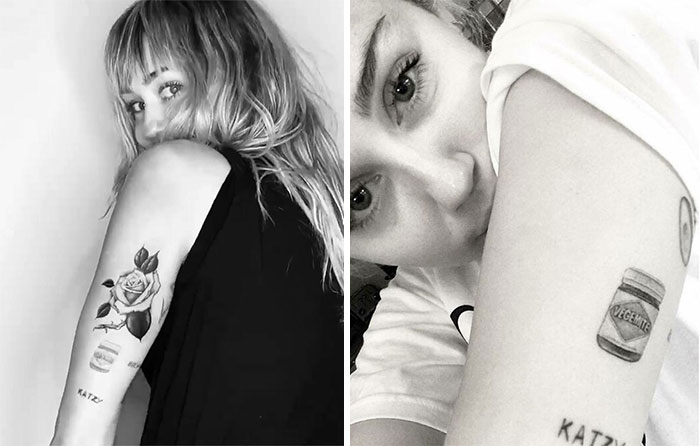 Close-up of a celebrity showcasing arm tattoos, including a rose and a jar design.