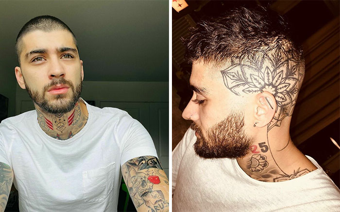 Man with intricate tattoos on neck and head, posing at home, wearing a white shirt.
