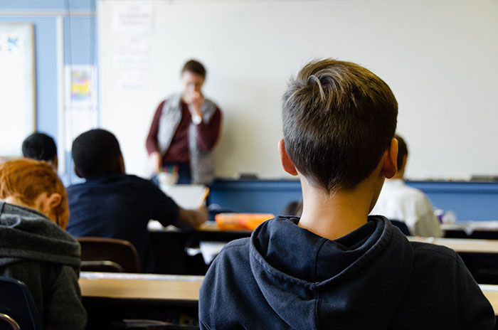 Boy sitting in their classroom at school