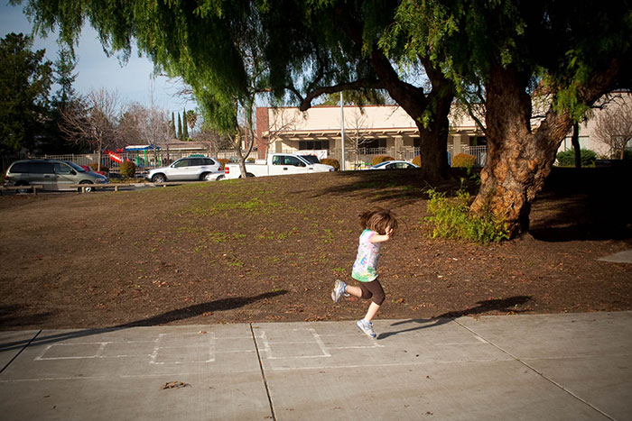 Kid playing hop scotch