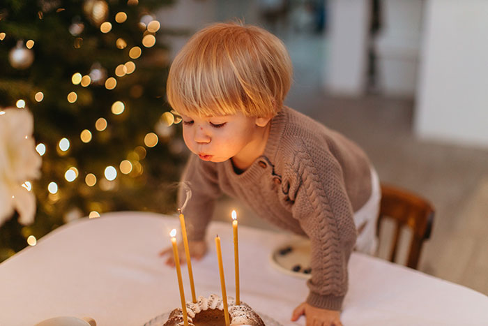Boy blowing out candles