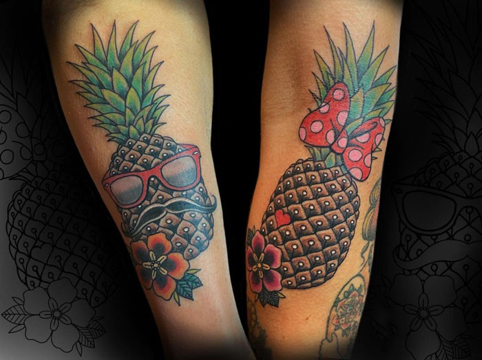 Matching pineapple tattoos with sunglasses and a bow, perfect for couples and friends seeking unique designs.