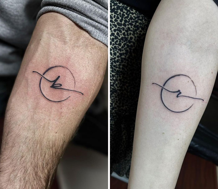 Matching tattoos with abstract design on two people's arms, symbolizing connection and unity.