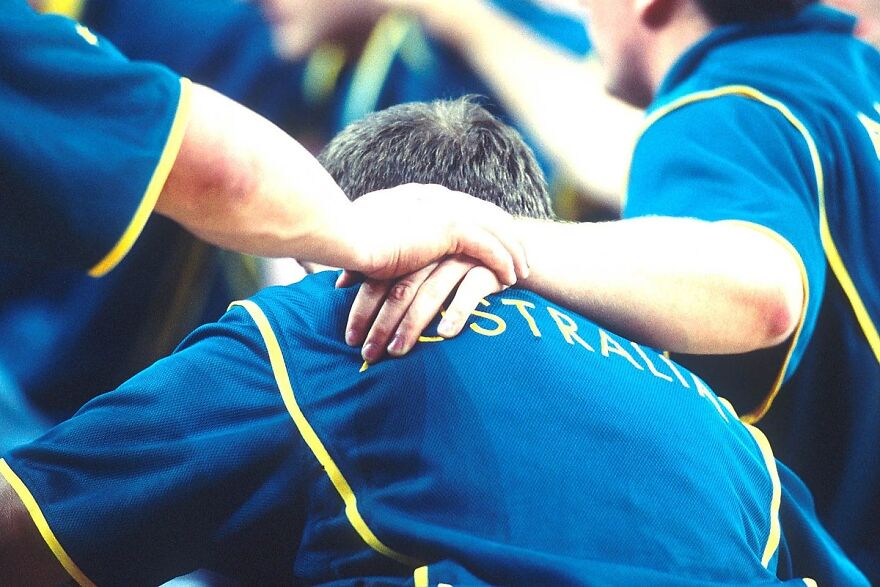 Australian men's wheelchair basketball team support each other during 2000 Sydney Paralympic Games match