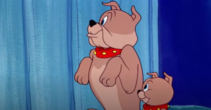 Two cartoon dogs with red collars standing in front of a blue curtain, showcasing cuteness and character.