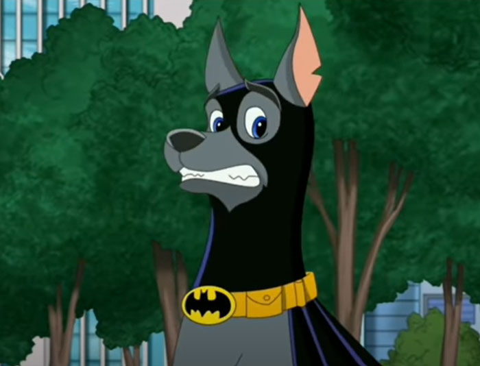 Cartoon dog in superhero mask and cape with a nervous expression, standing in a park setting.
