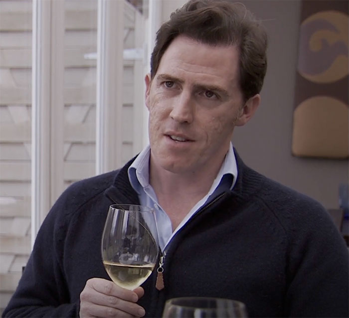 The Trip character wearing blue sweater