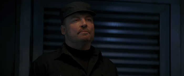 Stacy Keach looking at someone in the dark 