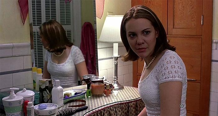 Larisa Oleynik Looking at someone in a bathroom 