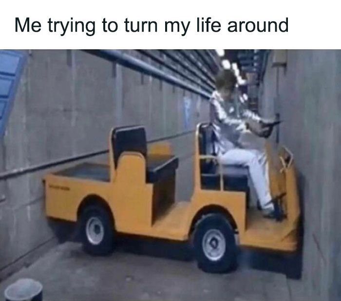 A person struggles to turn a small cart in a narrow hallway, illustrating a relatable meme moment.