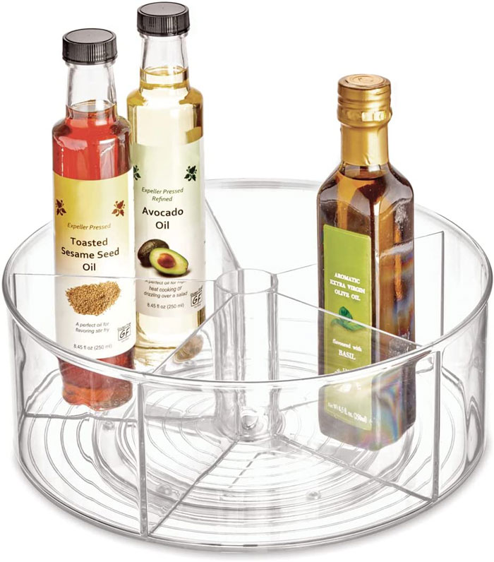 Home organization idea: Clear rotating spice rack holding sesame, avocado, and olive oils.