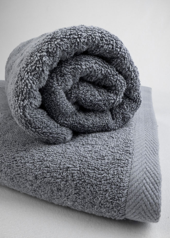 Gray towels neatly folded, showcasing effective home organization ideas.