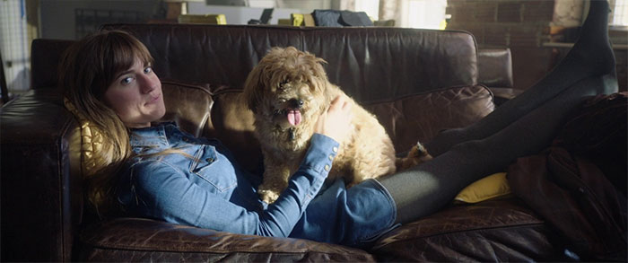 Rose on a couch with the dog 