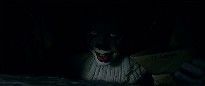 Pennywise holding a paper boat 