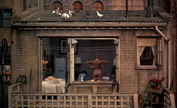 A man standing in front of the window