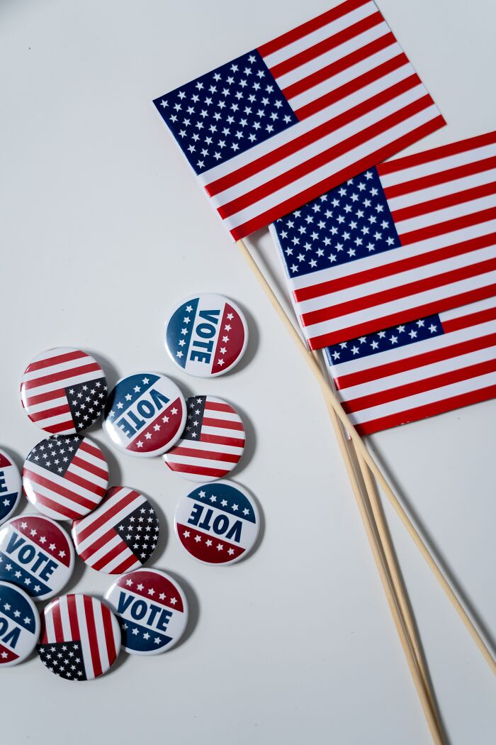 American Flags And Pins On The Table 