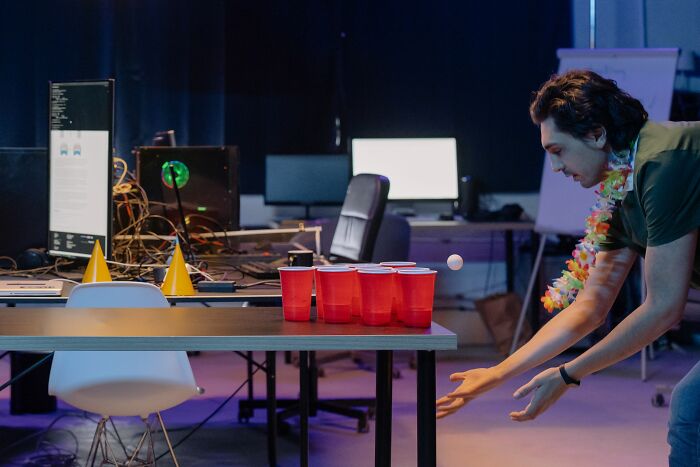 Guys Playing Beer Pong With Red Cups 