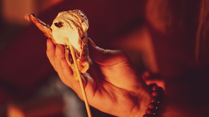 Person Eating Smores Near The Fire 