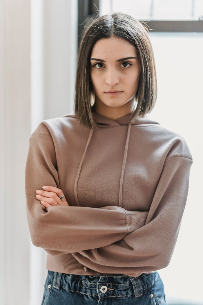 Woman Standing With Attitude And Crossed Hands 