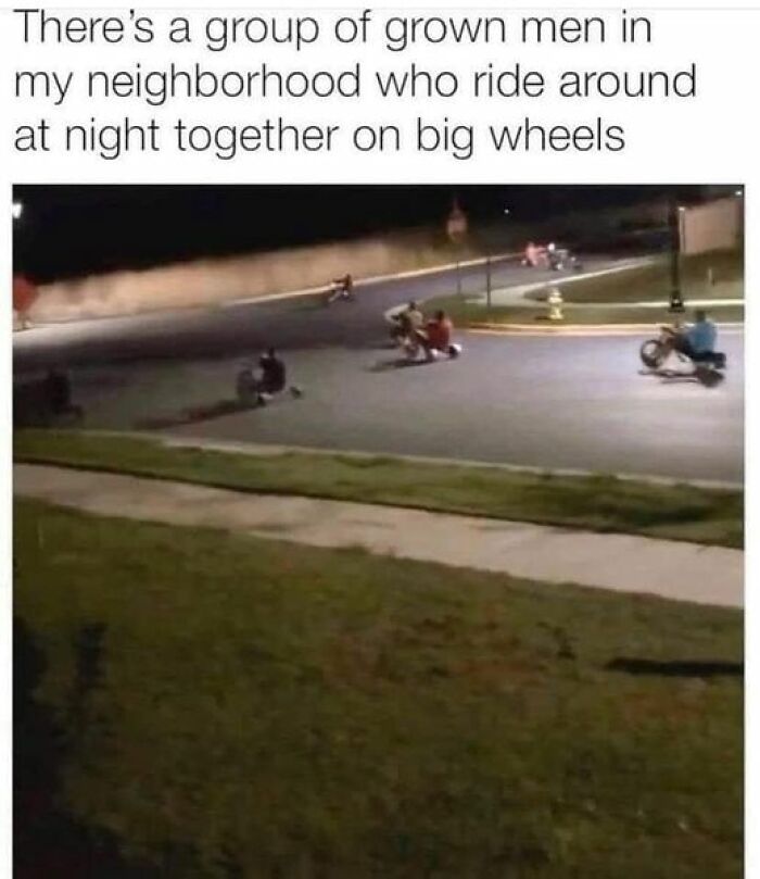 Grown men riding big wheels at night on a street, humorously capturing the essence of dad jokes.