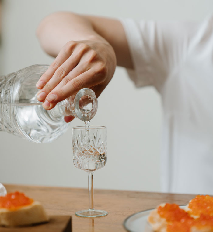 Person pours water in cup