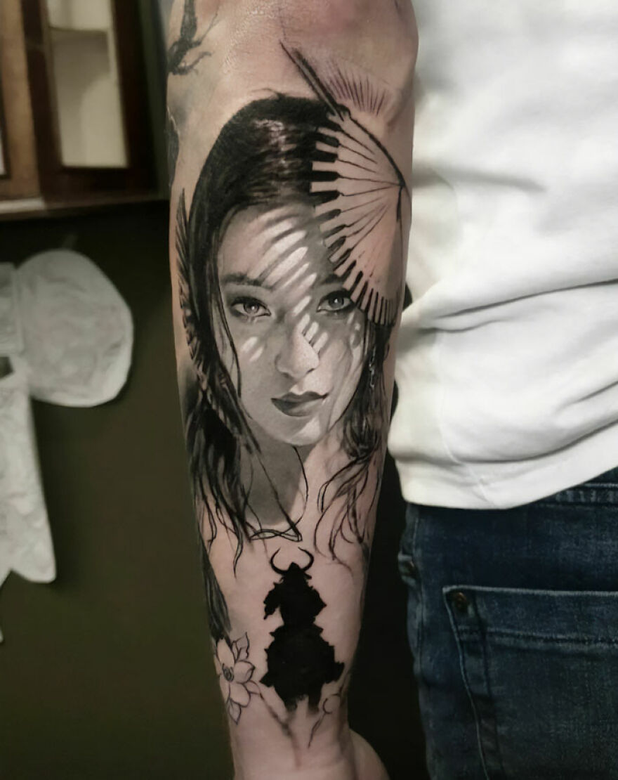 Super realistic tattoo of girl portrait and warrior on arm, showcasing intricate detailing.