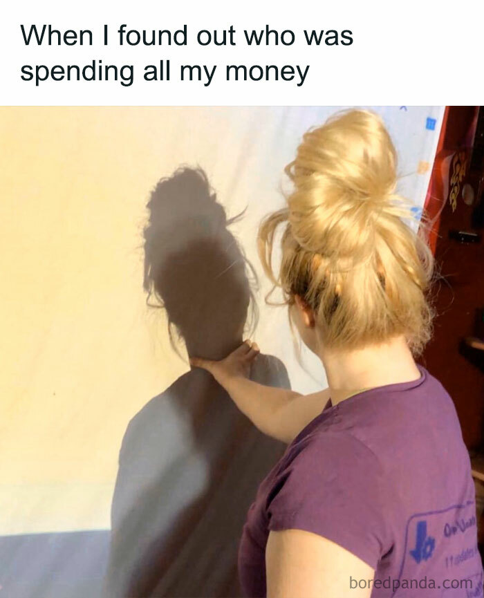 Woman pointing at her own shadow, illustrating a funny money meme.