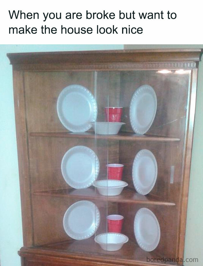 Display cabinet with paper plates and red plastic cups, representing humorous money-saving decor ideas.