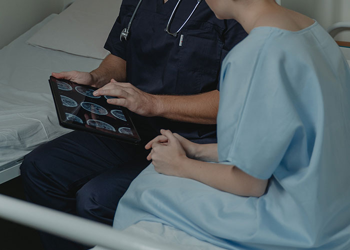 A doctor showing a patient medical scans, illustrating the scariest scientific discoveries with real-world implications.