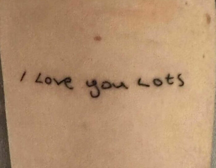 Tattoo with "I Love You Lots" phrase celebrating self-love on skin.