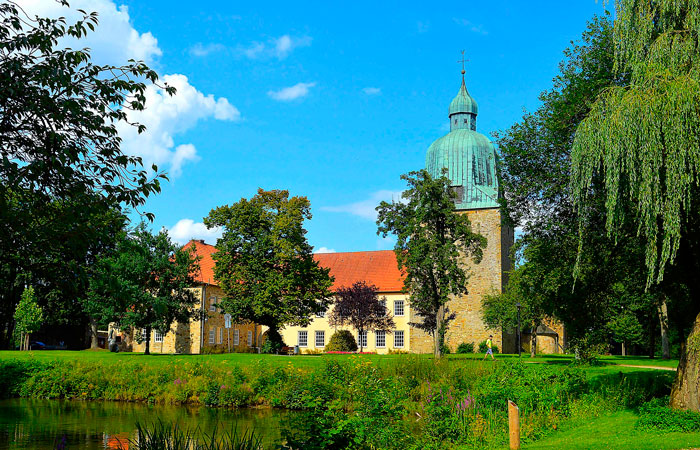 Building in a park near a pond 