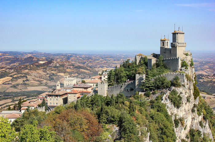 Multiple houses and a castle on a mountain 