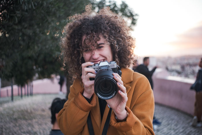 A curled hair woman preparing to take a shot