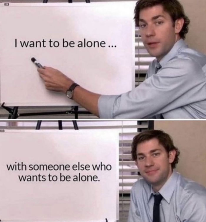 Man points to board with introvert meme text about wanting to be alone with someone who also wants to be alone.
