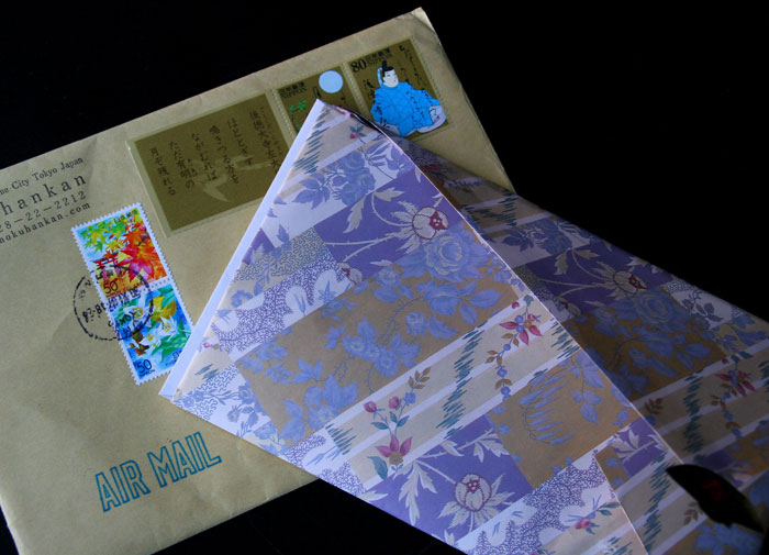 Decorative envelope and airmail package associated with a $500 gift being given away.