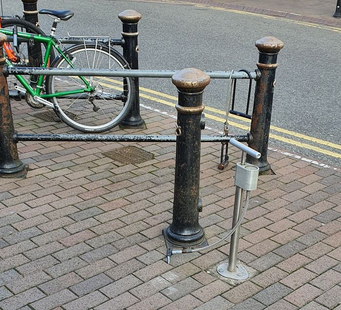 Innovative bike pump gadget installed in a city street for convenient use.