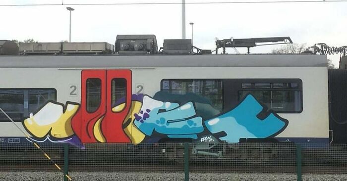 Colorful graffiti art on a train side, showcasing creative graffiti that transforms blank walls into admired objects.