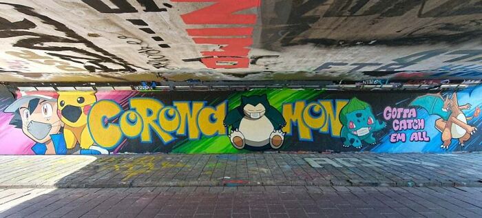 Colorful graffiti art featuring popular Pokémon characters painted on a large urban wall transforming the space.