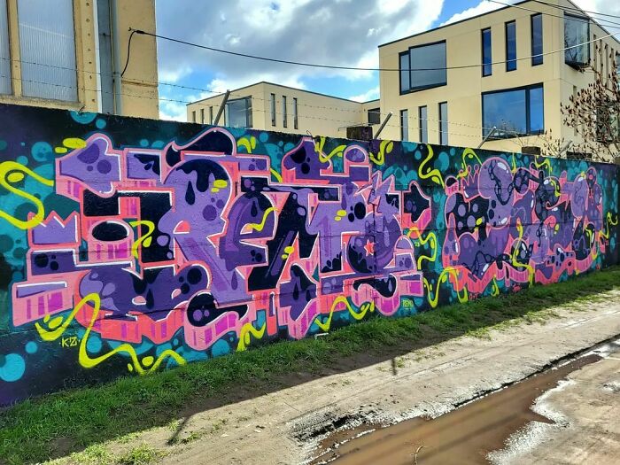 Colorful creative graffiti art covering a long wall in an urban area, turning blank walls into admired street art objects.